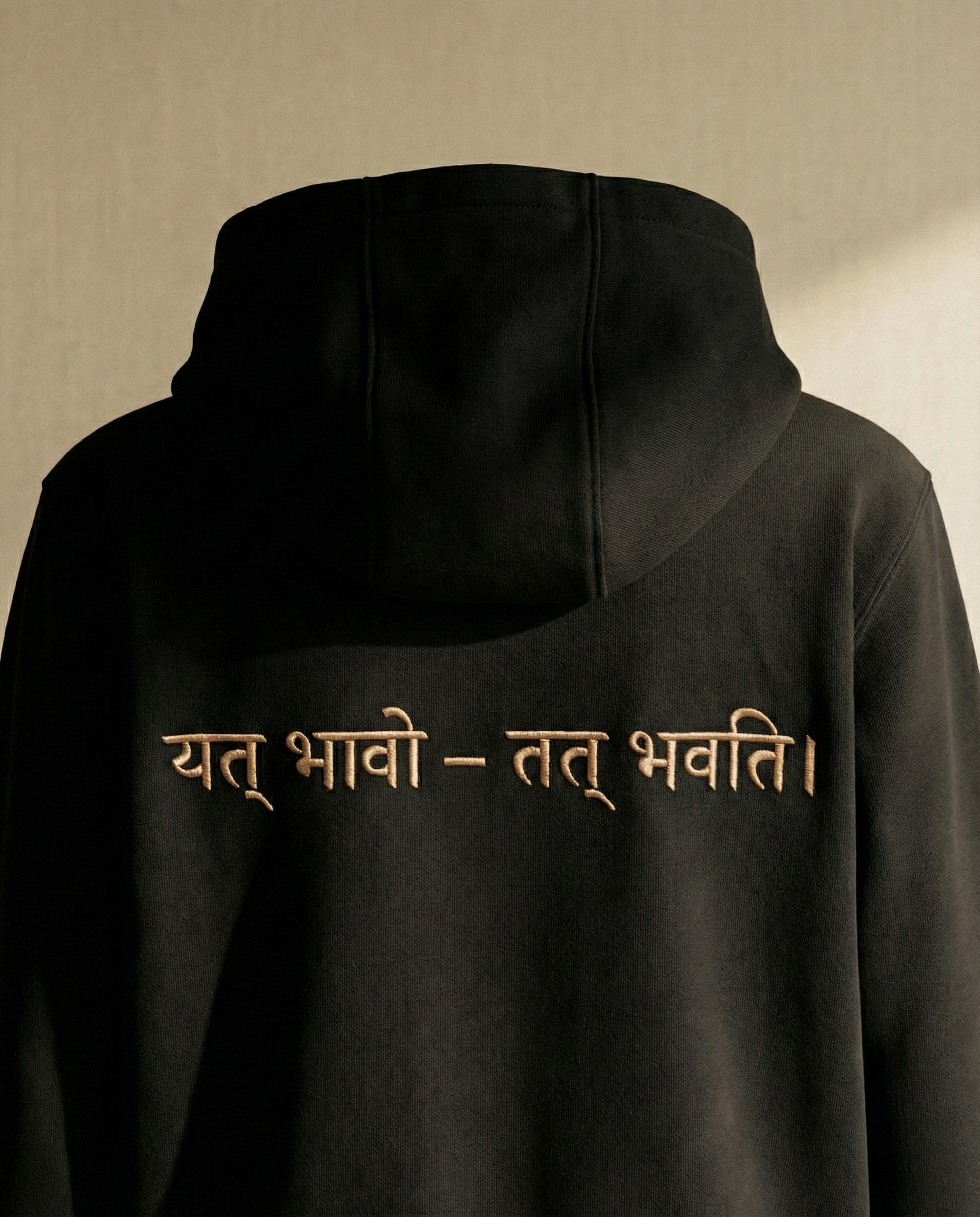 WOVYN Becoming Collection Hoodie - Obsidian Black, back view on a ghost mannequin with Sanskrit embroidery “यत् भावो – तत् भवति”